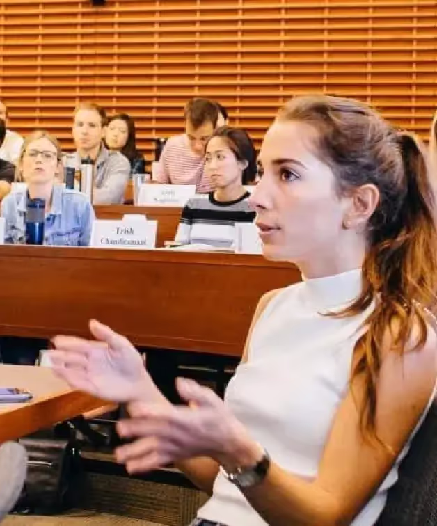 A student speaking during a discussion in a tiered Stanford GSB classroom